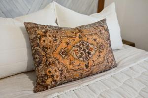 a pillow sitting on top of a bed at Vibey Units in Duplex #A & #B in Madison