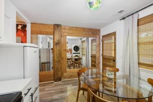 a kitchen and dining room with a glass table at Vibey Units in Duplex #A & #B in Madison