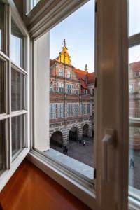 an open window with a view of a building at Old Town Heaven Apartment in Gdańsk