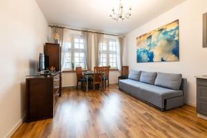 a living room with a couch and a table at Old Town Heaven Apartment in Gdańsk