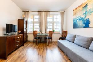 a living room with a couch and a table at Old Town Heaven Apartment in Gdańsk