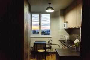 a kitchen with a small table and a window at Loft Centr in Tiraspol