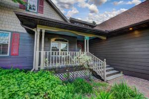 a house with a porch with a white railing at Eagles Haven in Eagle River +34 photos
