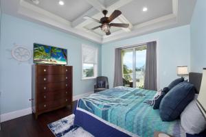 a bedroom with a bed and a ceiling fan at Ocean View, Gulf Access, Close to Beach, Private heated Pool - Island Waters - Roelens in Fort Myers Beach +50 photos