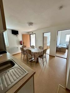 a kitchen and dining room with a table and chairs at Chata 3 in Nový Přerov +7 photos