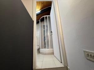 an open doorway to a bathroom with a toilet in a room at Hosting Dreams Attics - Duomo in Milan +121 photos