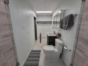 a bathroom with a toilet and a sink at Urban Treehouse in Dallas +8 photos