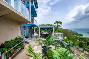 a balcony of a building with a view of the ocean at GARNET--A gem at DEE'S PEARL in Carriacou