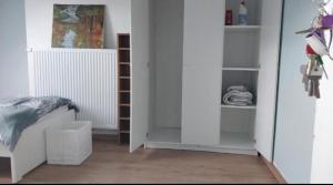 a room with white shelves and a white couch at Chambre 2 lit séparé 3eme etage in Brussels