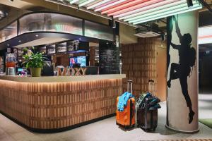 two bags of luggage standing in front of a lobby at Moxy Annecy in Annecy