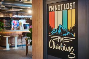 a sign that says im not lost in climbing at Moxy Annecy in Annecy