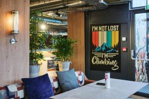 a table in a restaurant with a sign that says im not just climbing at Moxy Annecy in Annecy