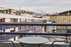 a view from a balcony with a table and chairs at Moxy Annecy in Annecy