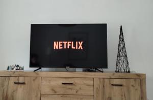 a television on top of a wooden entertainment center at Central near station in Bardonecchia