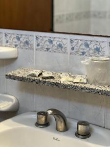 a sink with a faucet in a bathroom at Hotel Dali in San Rafael +17 photos