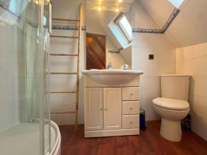 a bathroom with a sink and a toilet and a shower at Maison bretonne 2 personnes centre ville St Pol de Léon in Saint-Pol-de-Léon