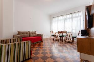 a living room with a couch and a table and chairs at SUH Leme 01 Beach Spacious in Rio de Janeiro