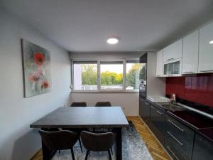 a kitchen with a table and chairs in a room at Apartment Ema with garage in Velika Kladuša