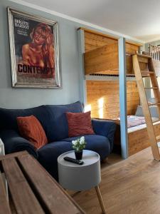 a living room with a couch and a bunk bed at Pension Adele - Ruhig, direkt am Elberadweg & Badesee mit Balkon in Dresden