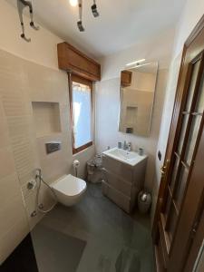 a bathroom with a sink and a toilet and a mirror at Campidoglio vacation home in Lenno +33 photos