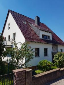 a white house with a red roof at Golden Hour Apartment in Kaiserslautern