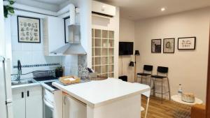 a kitchen with white cabinets and a counter top at Holiday, business trips in pujos in Hospitalet de Llobregat