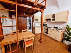 a kitchen with a wooden table and a dining room at Eliza Old Town Apartment in Košice +4 photos