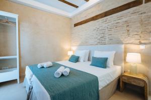 a bedroom with a bed with two towels on it at New Hostly Arenal in Seville +95 photos