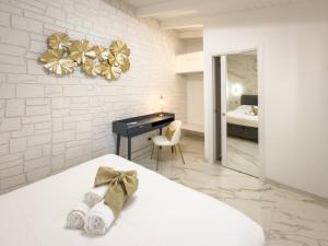 Ένα ή περισσότερα κρεβάτια σε δωμάτιο στο MARBEL SUITES Casamassima