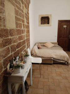 a bedroom with a bed and a brick wall at La Casa Di Miri in Foligno +46 photos