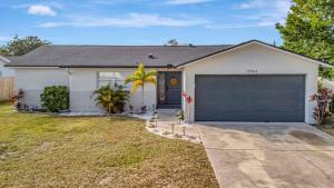 a white house with a garage at Heated Pool 3b&2b home in Largo