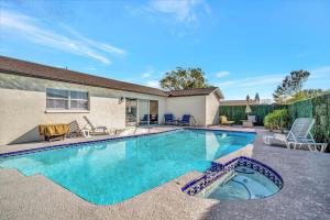 a swimming pool in the backyard of a house at Heated Pool 3b&2b home in Largo