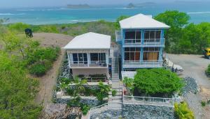 an aerial view of a house with the ocean at ONYX-- A Gem at DEE'S PEARL in Carriacou +48 photos