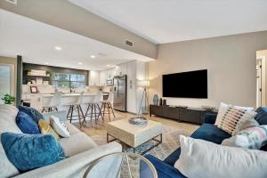 a living room with a couch and a tv at Heated Pool 3b&2b home in Largo