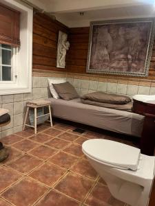 a room with a bed and a toilet in it at Sentrum Lillesand unique accommodation in Lillesand