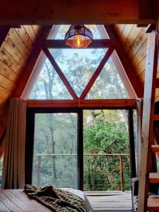 a room with a large window in a cabin at High garden alpine cabin in San Lucas Sacatepéquez +31 photos