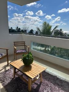a room with a table and a view of a balcony at Vista al Caribe in Los Mameyes
