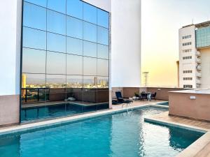 a swimming pool on the roof of a building at Vivence Hotel Palmas in Palmas