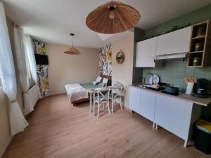 a kitchen with a table and a counter top at Le Petit Marais in Saint-Martin-lez-Tatinghem