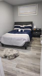 a bedroom with a bed and a rug on the floor at Mercy's lodge in Saskatoon