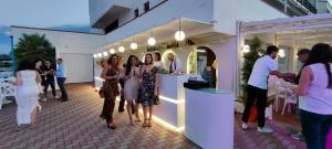 a group of people standing in front of a store at Residence La Bricola 239 in I Casoni