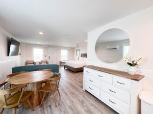 a living room with a table and a bedroom at 3001 King Suite, 3rd Floor Serenity in Surf City
