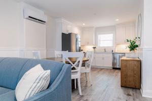 a living room with a blue couch and a kitchen at 3002 Queen Suite, 3rd Floor Surfside in Surf City