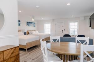 a living room with a bed and a table at 3002 Queen Suite, 3rd Floor Surfside in Surf City