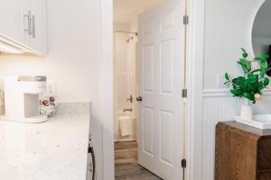 a kitchen with a white door and a sink at 3002 Queen Suite, 3rd Floor Surfside in Surf City +25 photos