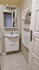 ein Badezimmer mit Waschbecken und Spiegel in der Unterkunft Levendula Vendégház in Nyírmeggyes + 24 Fotos