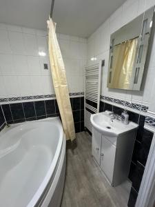 a bathroom with a tub and a toilet and a sink at Fenia Estate in Barking +77 photos