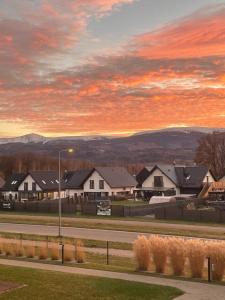 a group of houses on a street at sunset at Happy Moments - widokowy apartament in Jelenia Góra