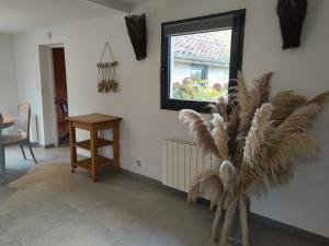 a living room with a table and a window at La cachette de Lola in Beaurainville