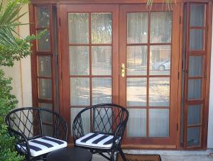 two chairs sitting in front of a door at The Guest Room, Barossa in Nuriootpa